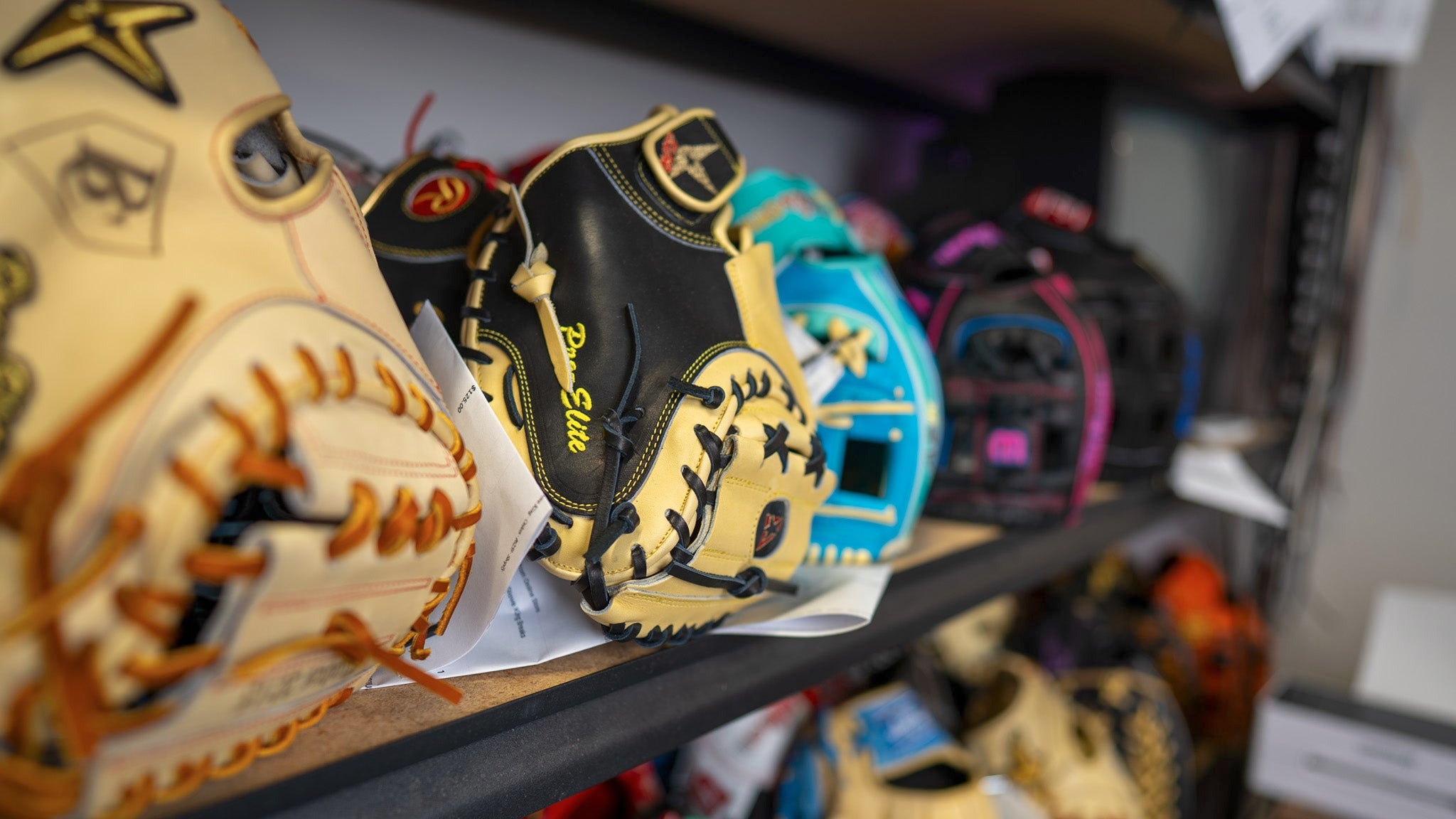 Collection of baseball gloves on a shelf